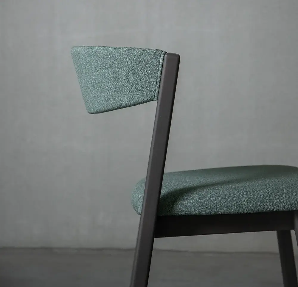 Side profile of a green fabric chair