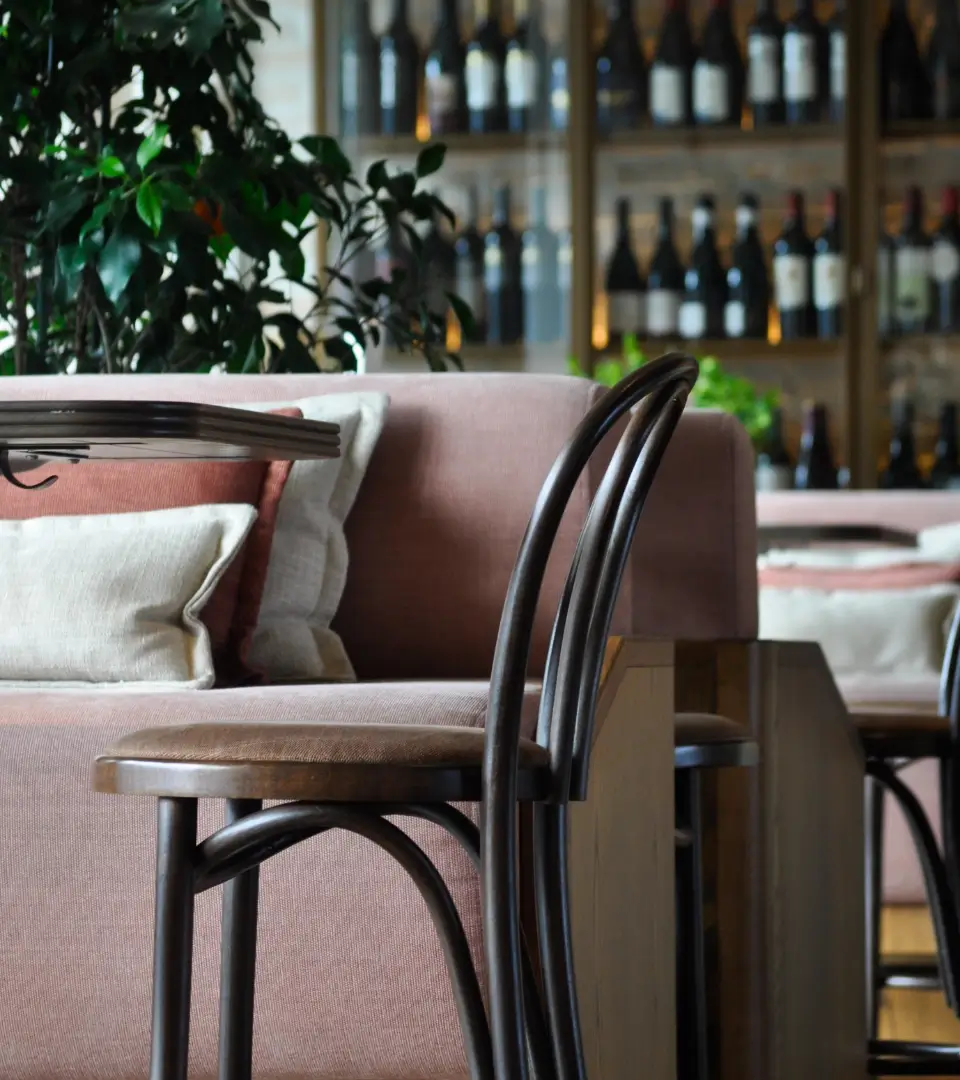 Single chair at a table with a couch in the backdrop